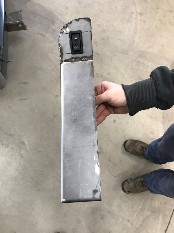 A person is holding a piece of metal in their hand