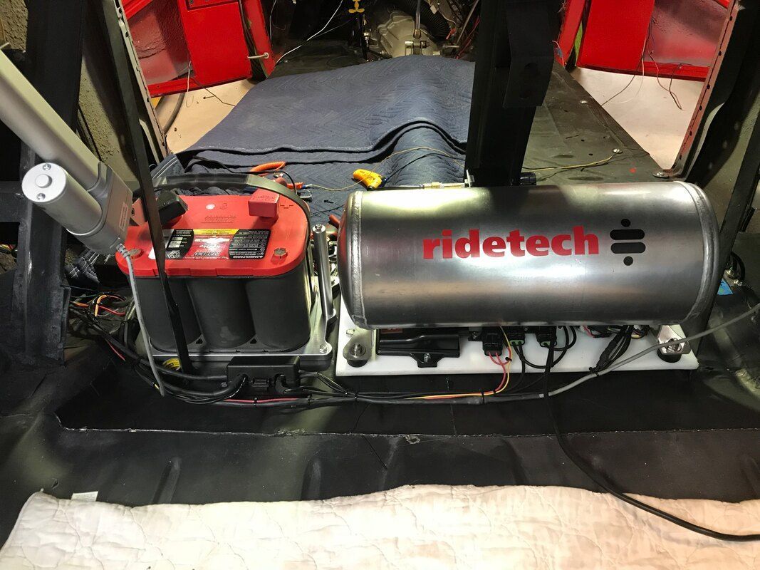 A ridetech air suspension system is being installed in a car.