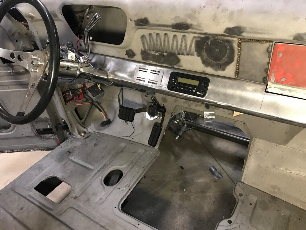 The inside of a car with a steering wheel and dashboard.