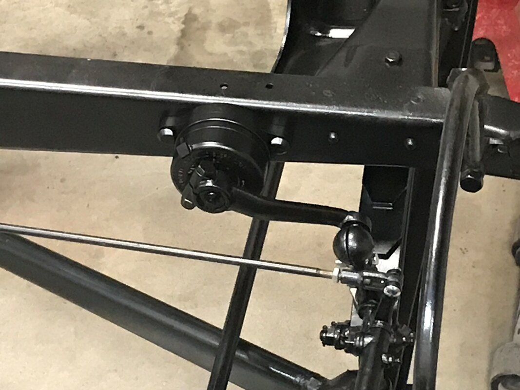 A close up of a metal frame with a brake pedal on it.