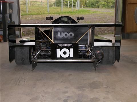 A black and white race car with a sign that says 101 on it
