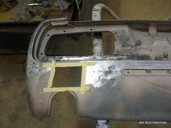 A piece of metal is sitting on a table with tape on it