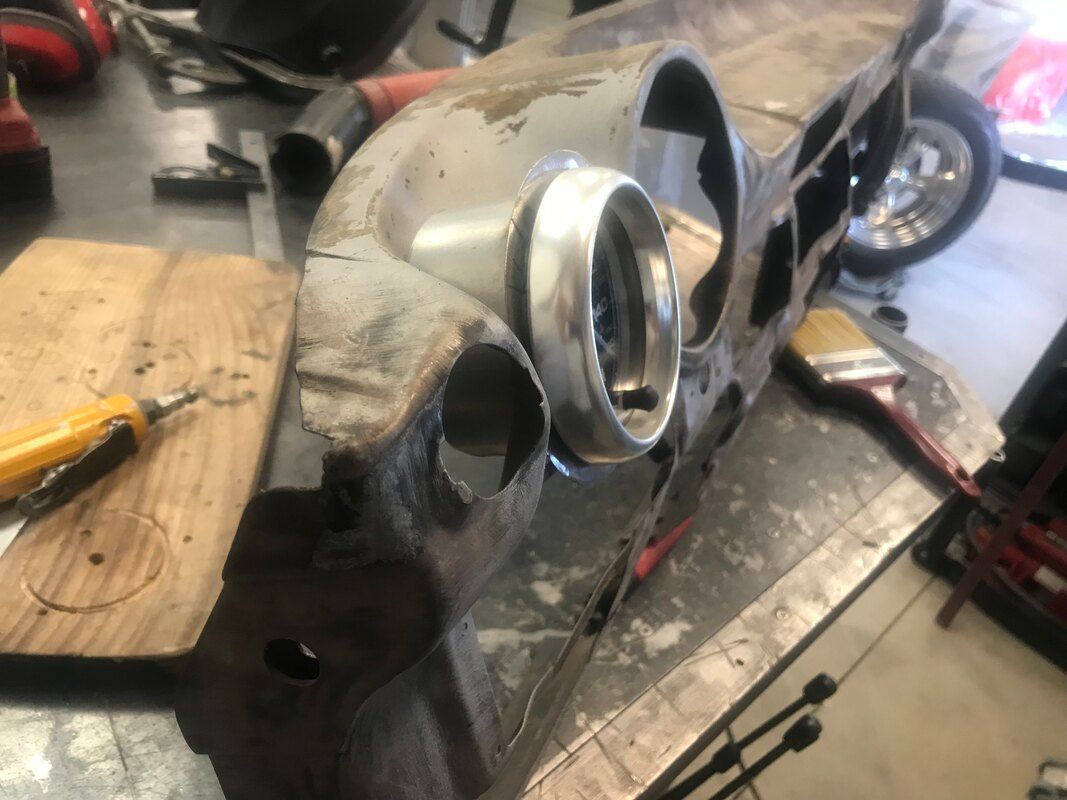 A piece of metal is sitting on top of a wooden table.