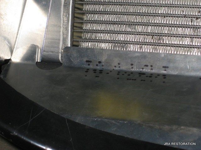 A close up of a radiator that says jra restoration on the bottom