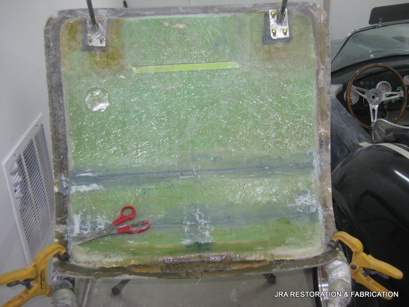 A pair of scissors is sitting on top of a piece of plastic.