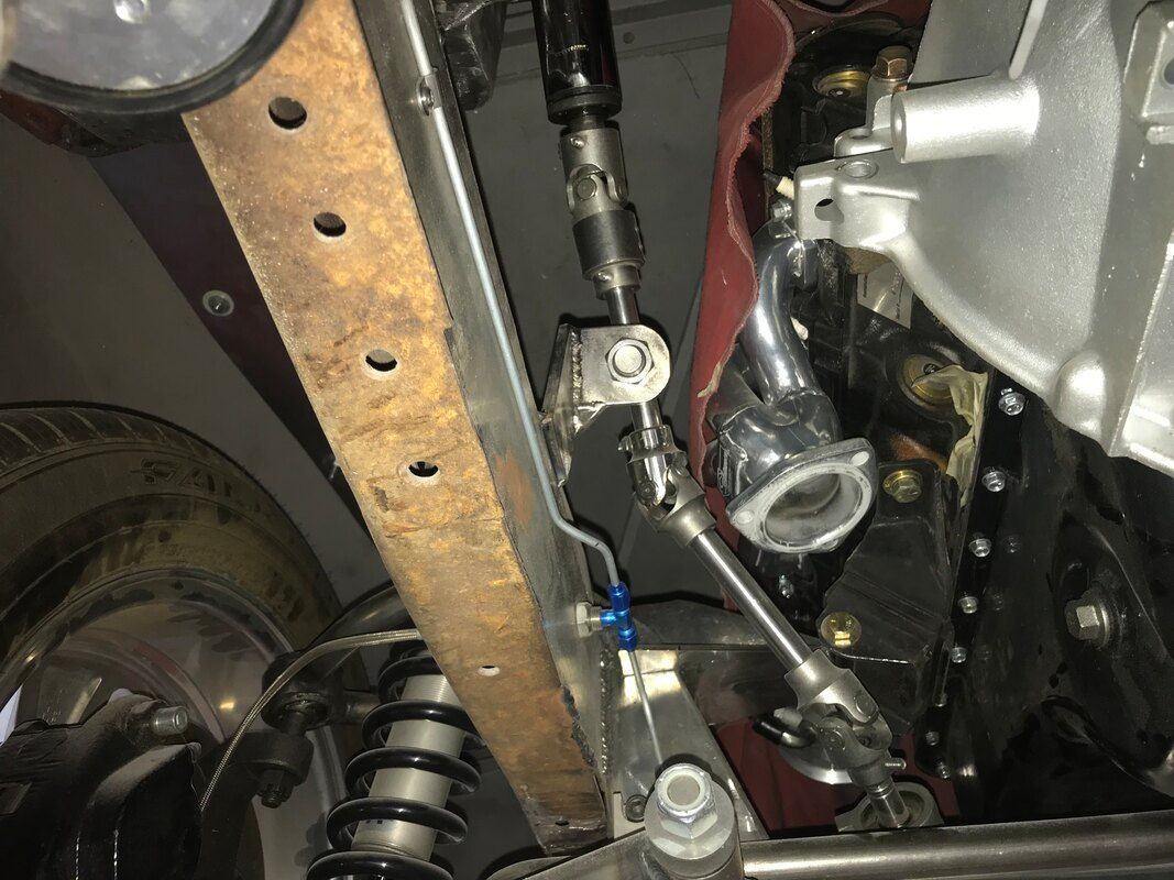 A close up of the underside of a car engine