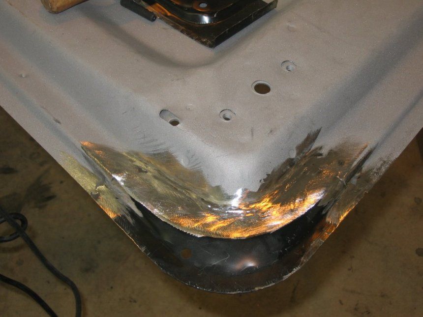 A piece of metal is being worked on with a hammer