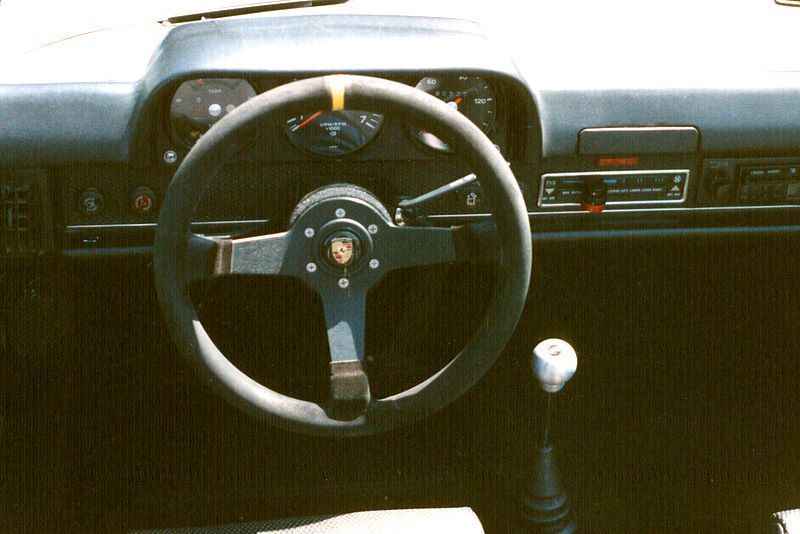 A close up of a steering wheel in a car