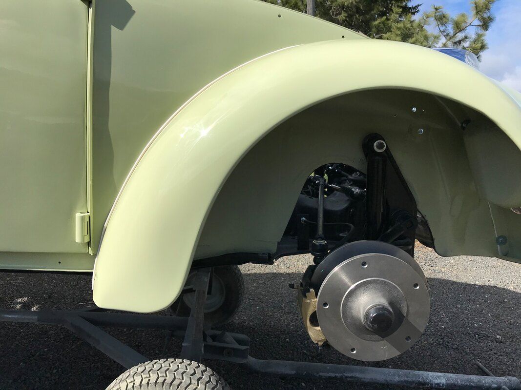 A close up of a car 's wheel and fender