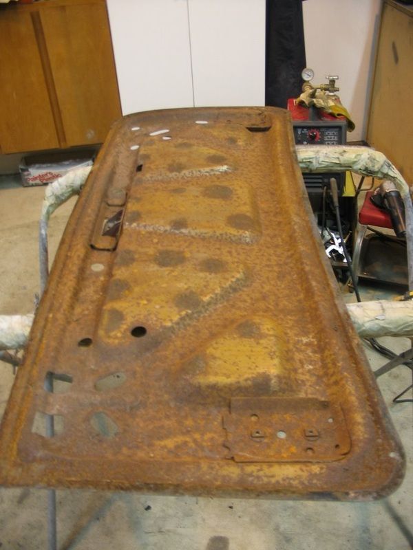 A rusty piece of metal is sitting on a table