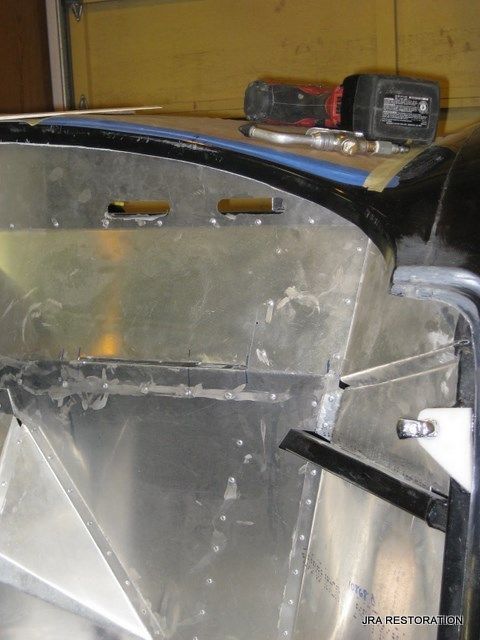 A drill is sitting on top of a piece of metal