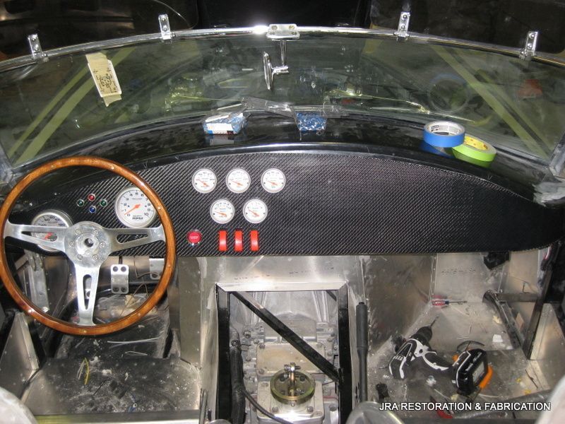 The inside of a car with a steering wheel and dashboard