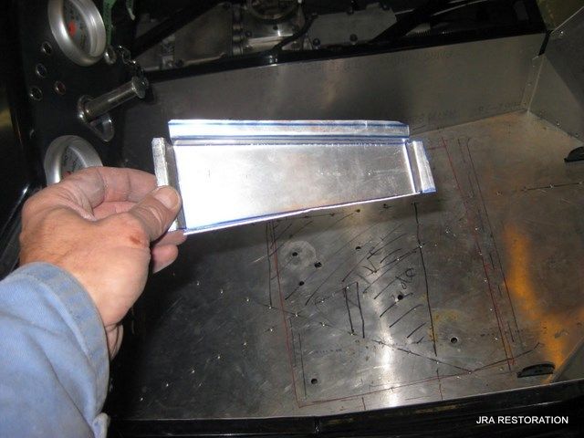 A person is holding a piece of metal in their hand