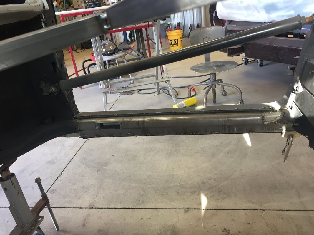 A piece of metal is sitting on the ground in a garage.