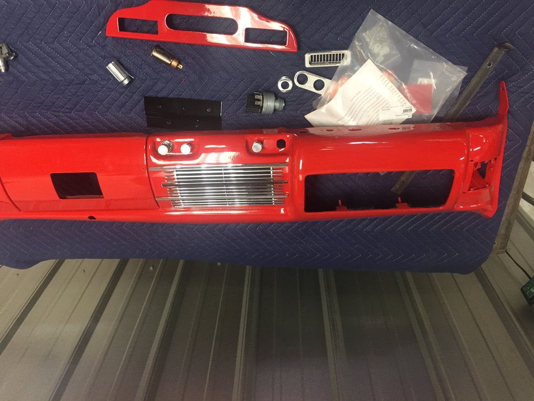 A red bumper is sitting on top of a metal roof.