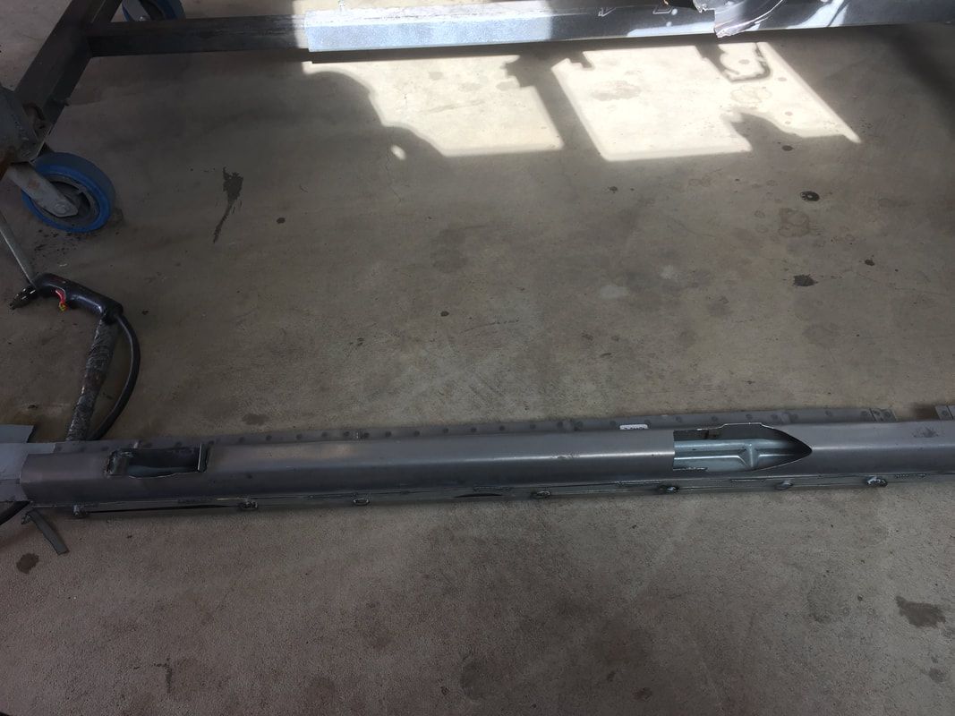 A piece of metal is sitting on top of a concrete floor.