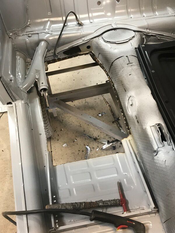 A car is being worked on in a garage.