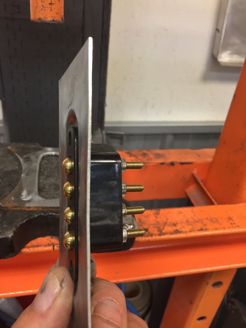 A close up of a person holding a piece of metal