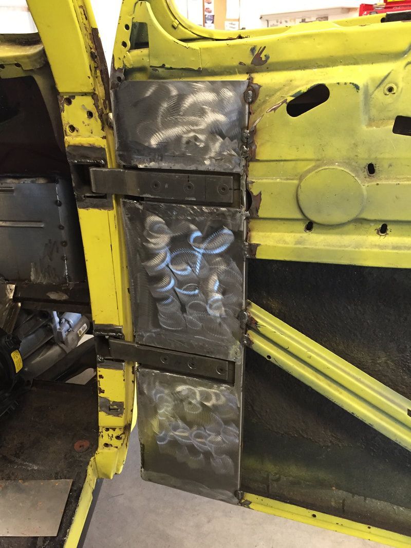 A yellow car is being worked on in a garage