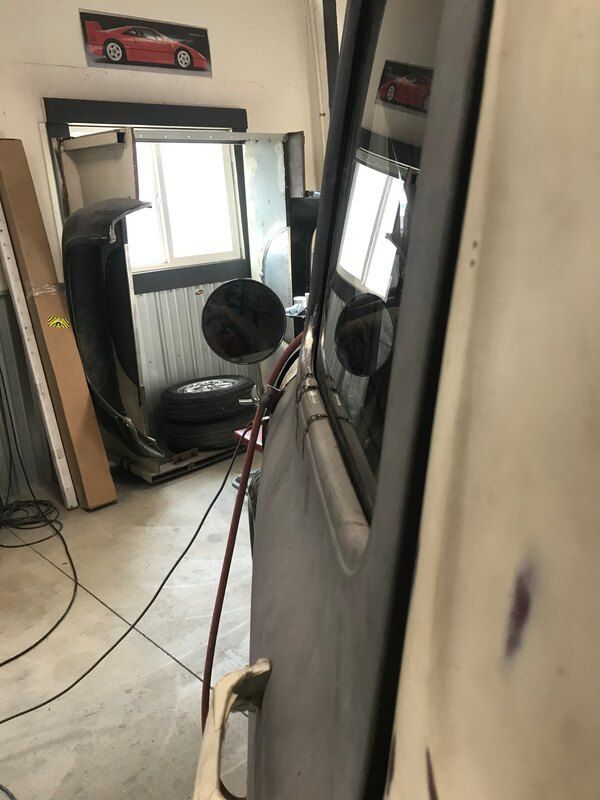 A room with a red car hanging on the wall