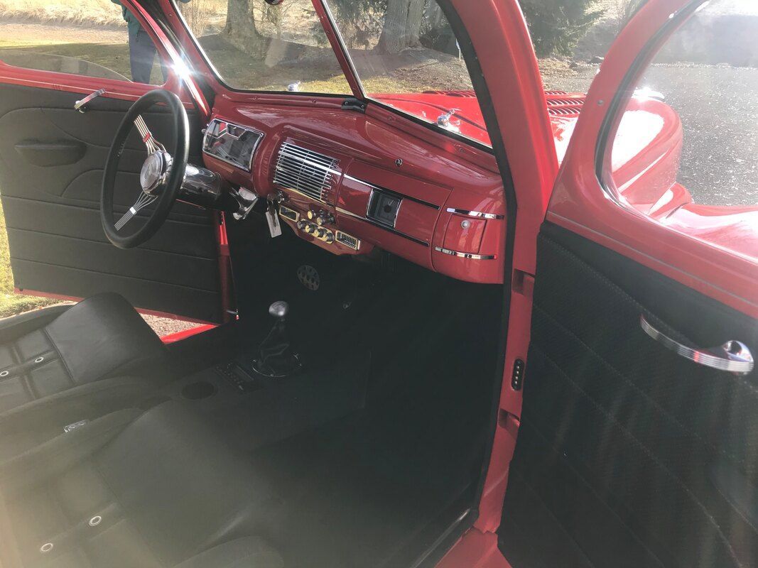 The inside of a red car with the door open.