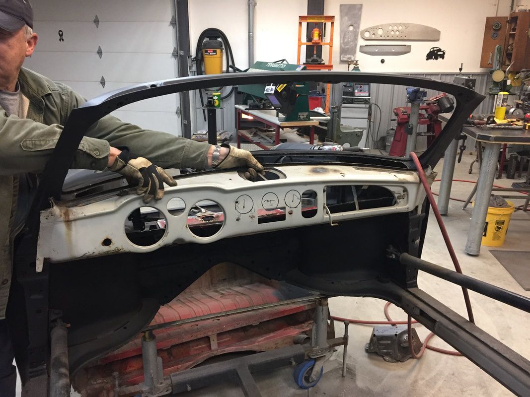 A man is working on a car in a garage