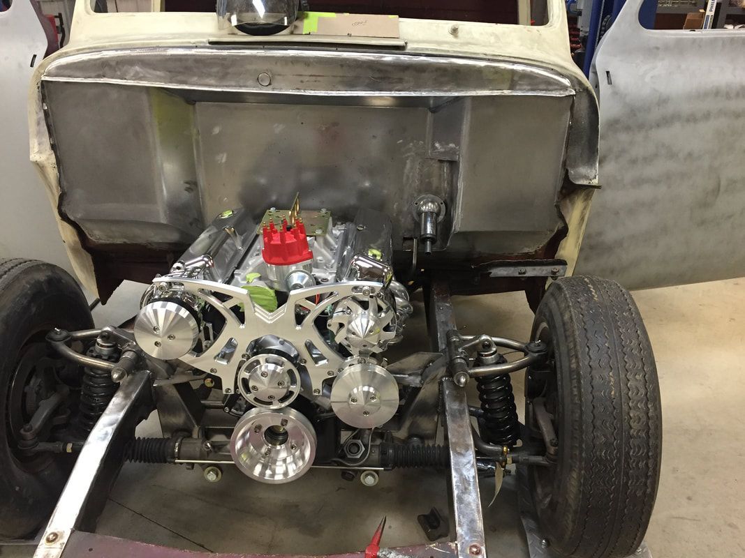 A car is being built with the engine visible.