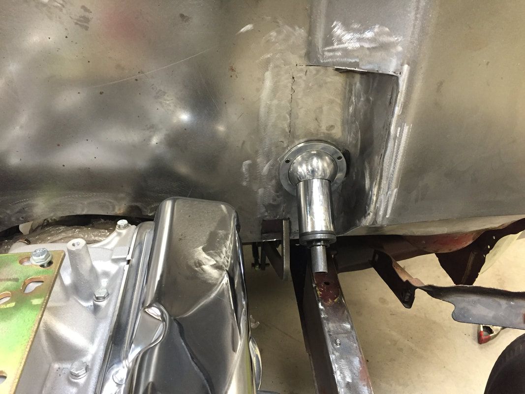 A close up of a metal object with a hose attached to it.