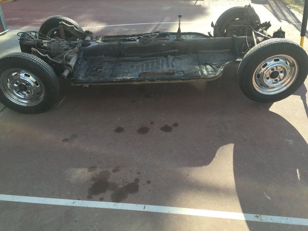 A car is sitting on the ground in a parking lot