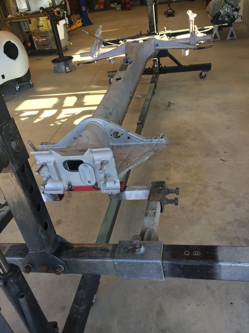 A piece of metal is sitting on a table in a garage.