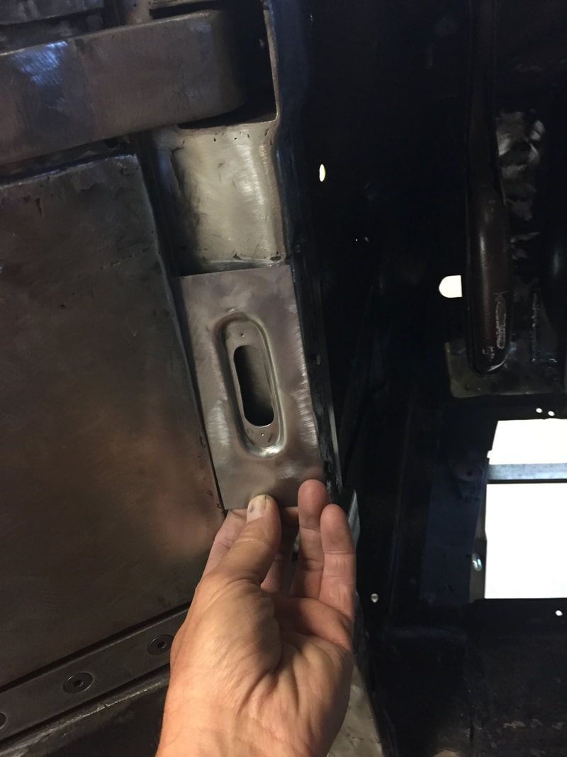 A person is holding a piece of metal in their hand.