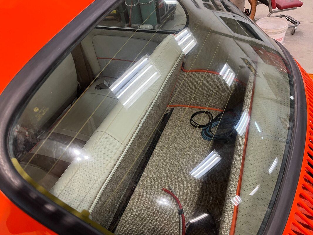 A close up of the windshield of an orange car