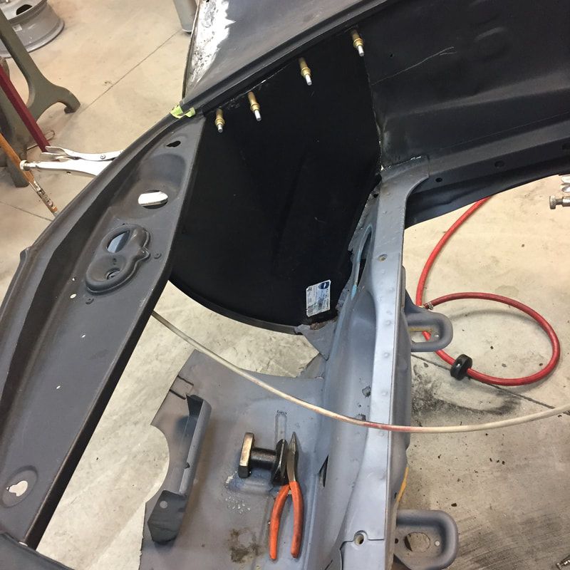 A car is being worked on with a pair of pliers