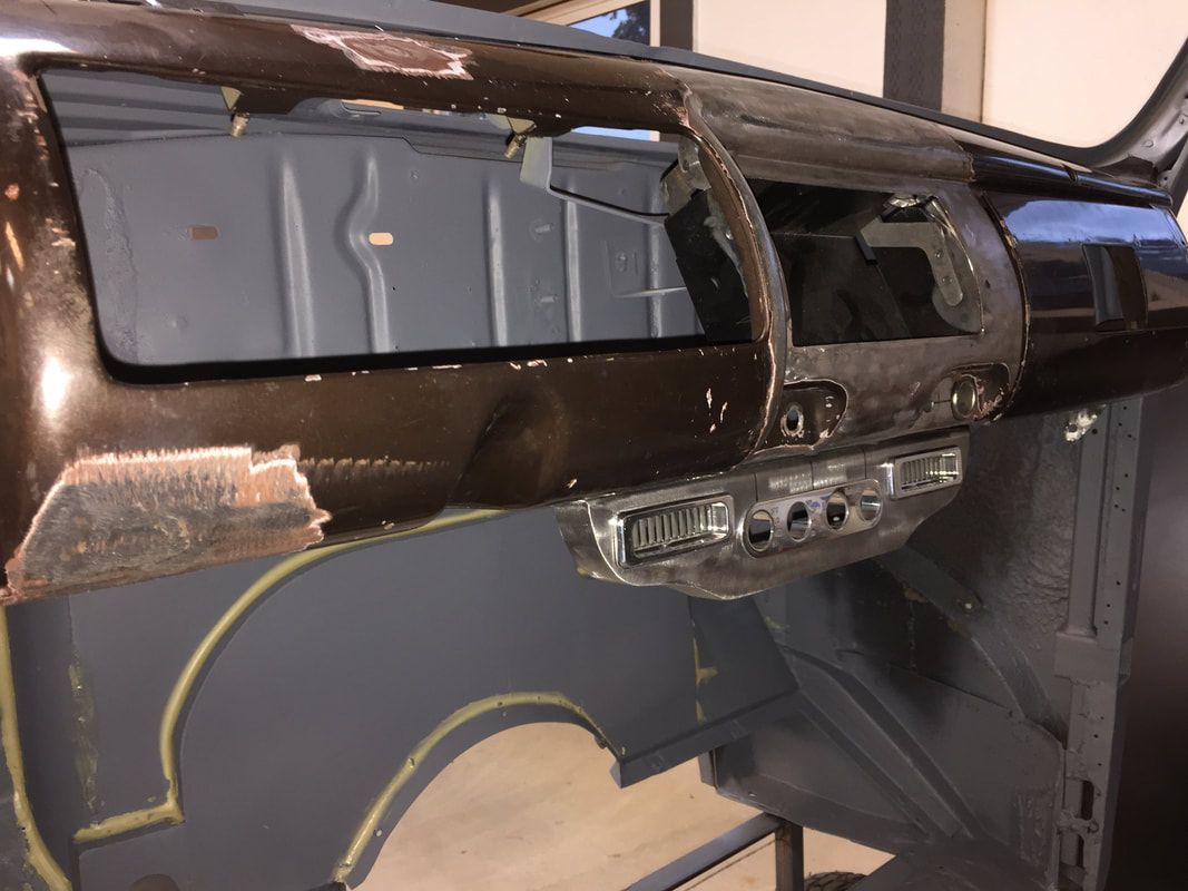 The dashboard of a car is being repaired in a garage.