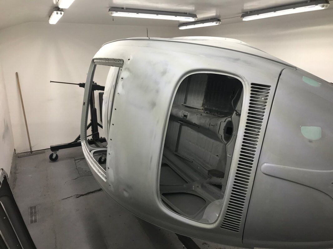 A car is sitting in a garage with the door open.