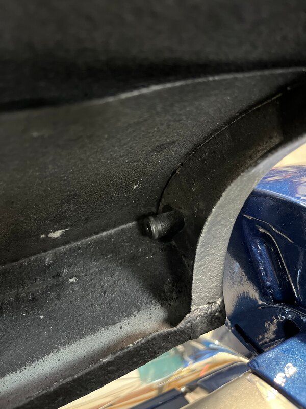 A close up of a metal object with a screw in it.