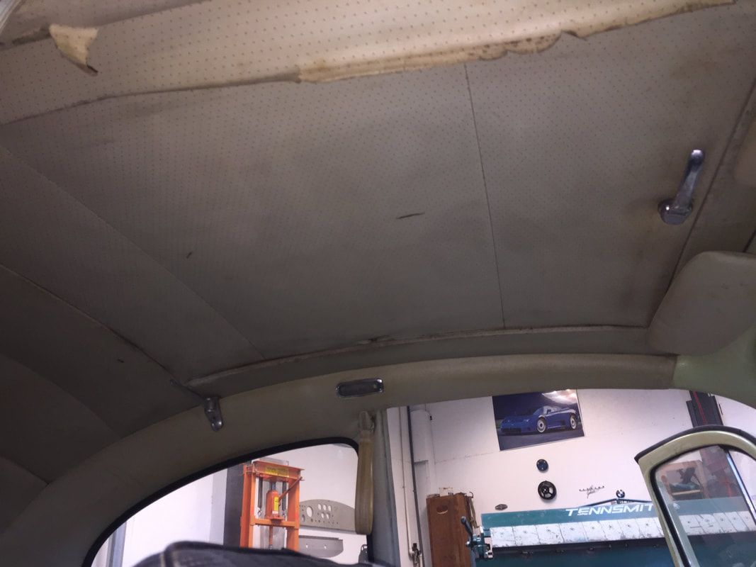 The inside of a car with the roof missing