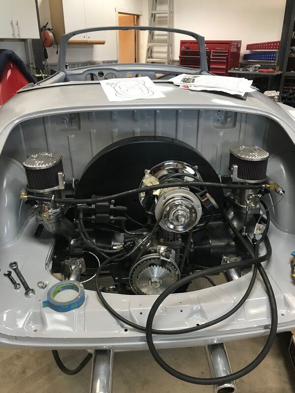 A car engine is being worked on in a garage.