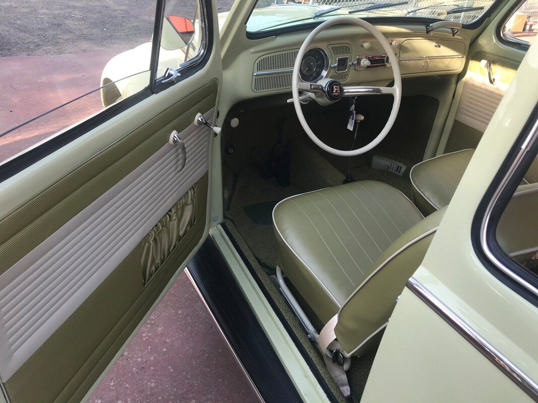 The inside of a volkswagen beetle with the door open