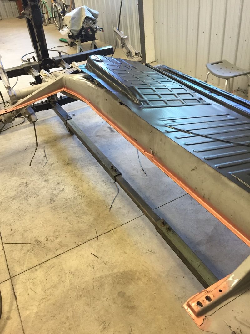 A treadmill is sitting on a concrete floor in a garage.