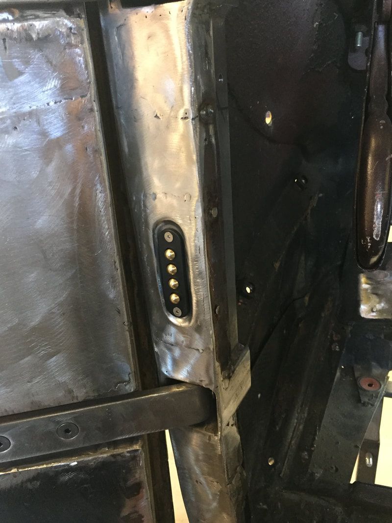 A close up of a metal object with a screw in it.