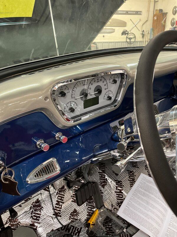 A close up of the dashboard of a car with a steering wheel.