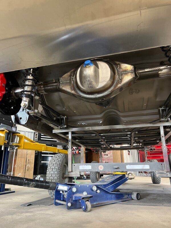 A car is being lifted on a jack in a garage.