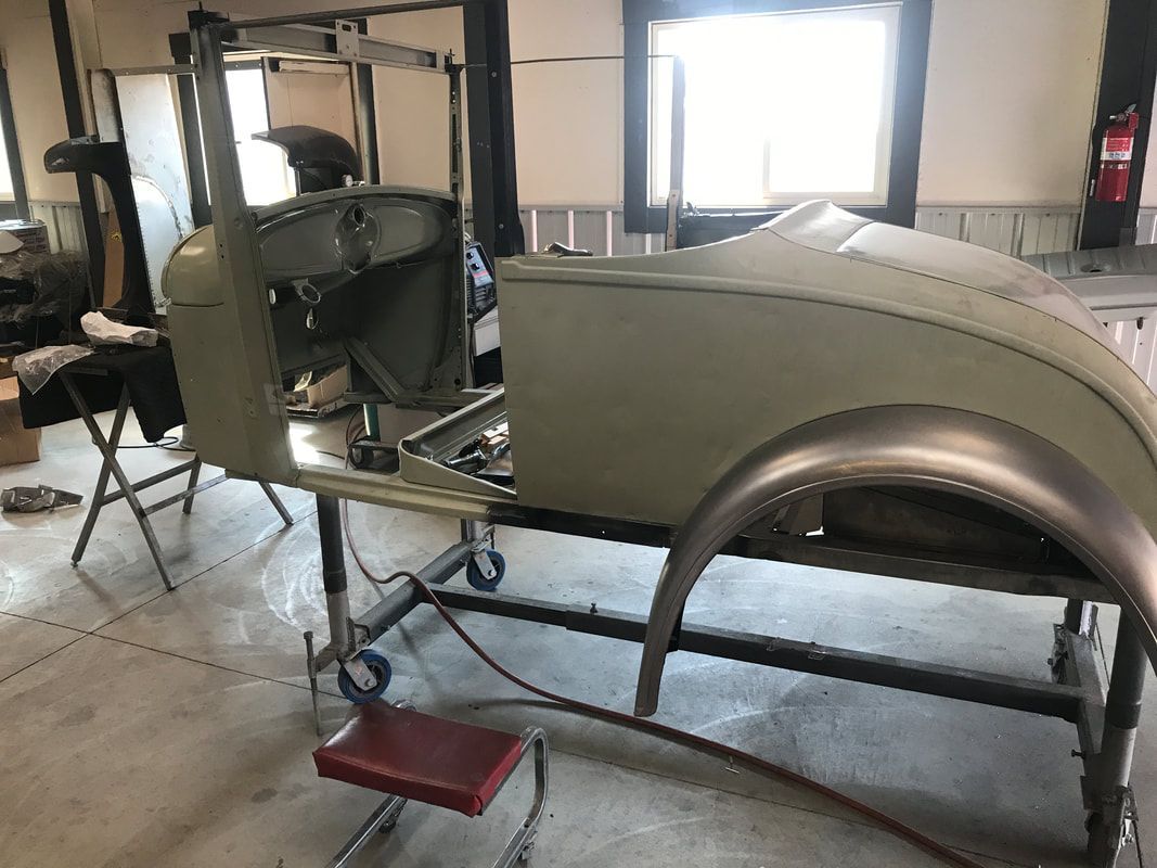 A car is being built in a garage.