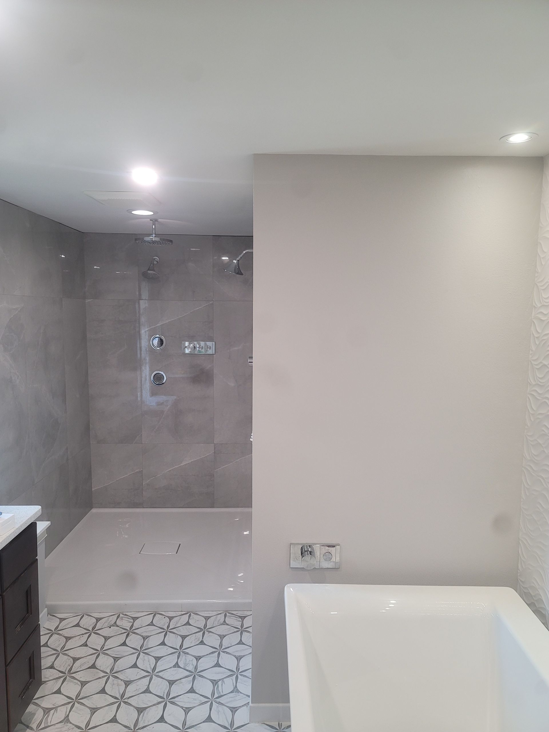 A bathroom with a walk in shower and a bathtub.