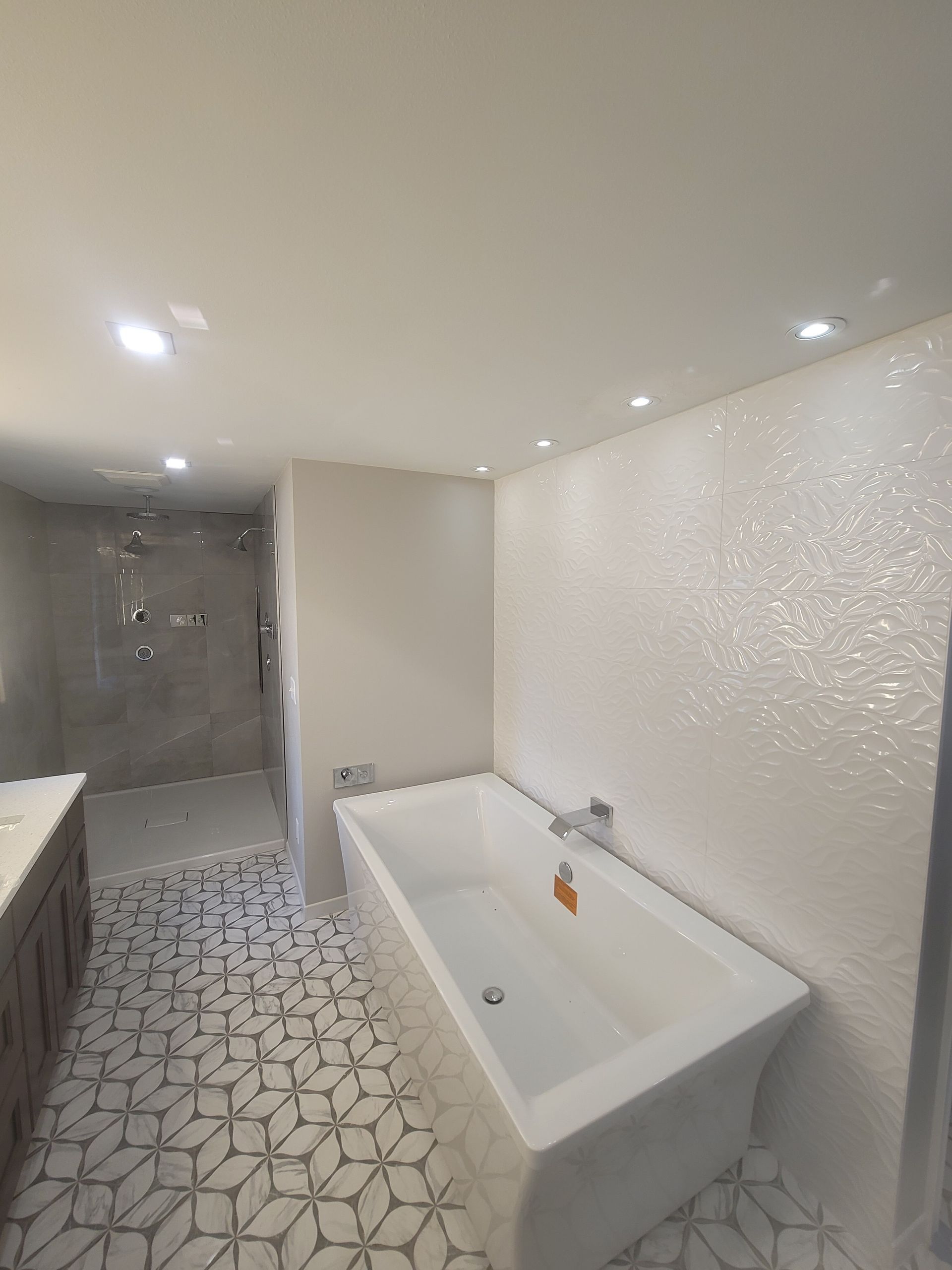 A bathroom with a bathtub and a shower.