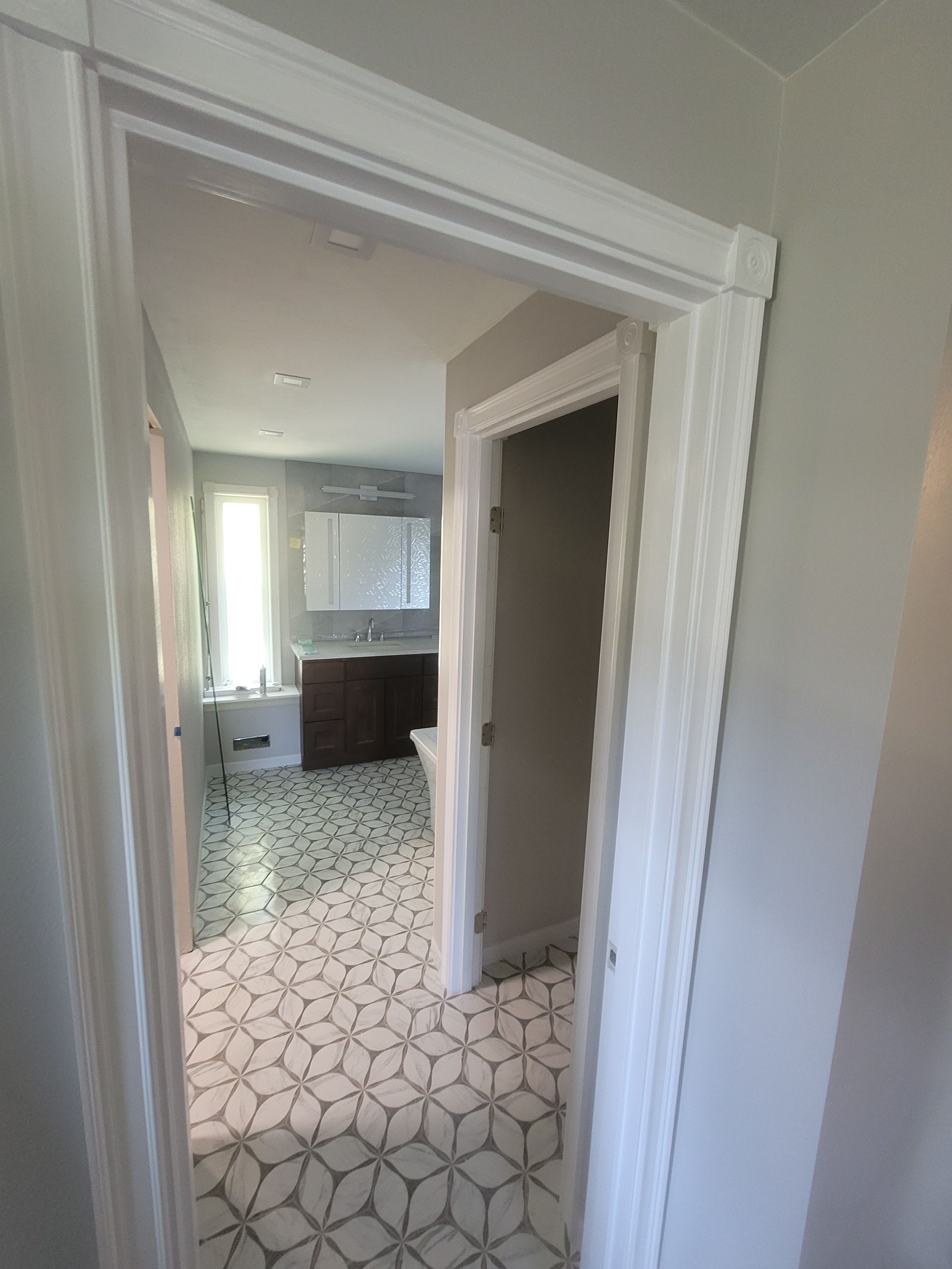 A bathroom with a bathtub , sink , and mirror.