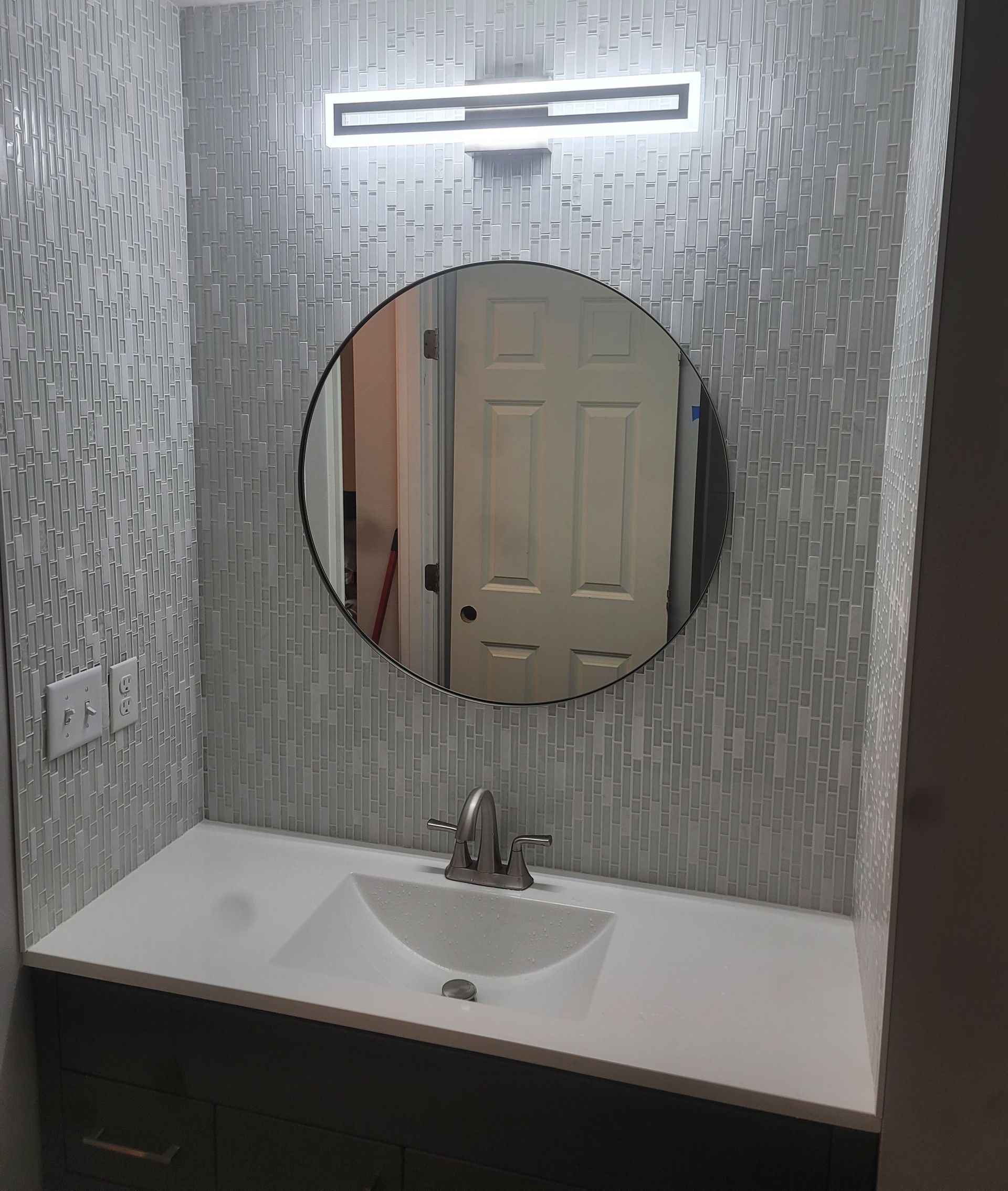 A large empty room with hardwood floors and a ceiling fan.