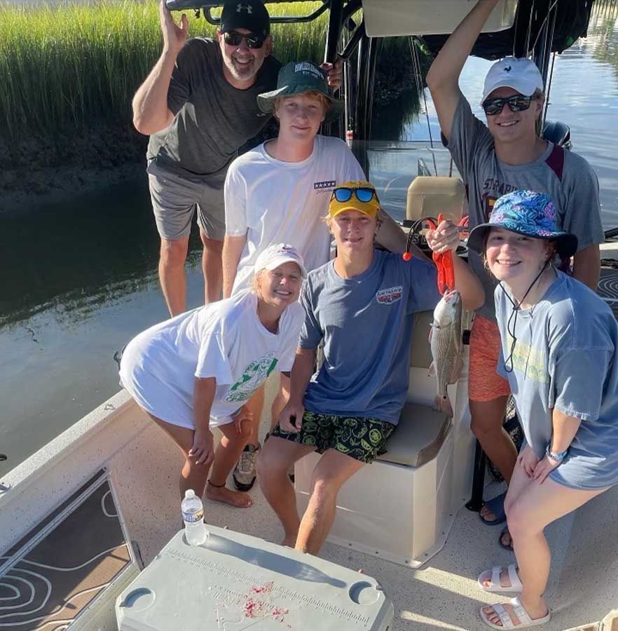 A group of people posing for a picture on a boat