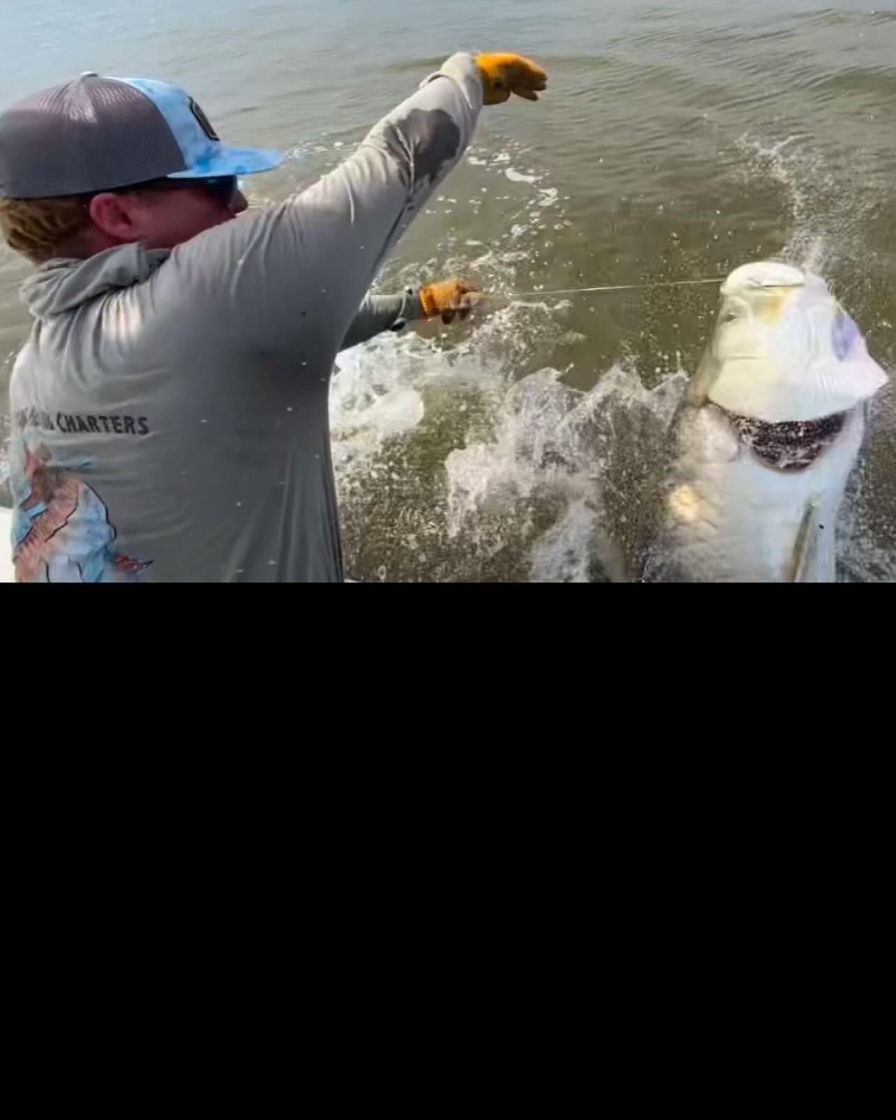 A man is fishing in the ocean with a fishing rod.